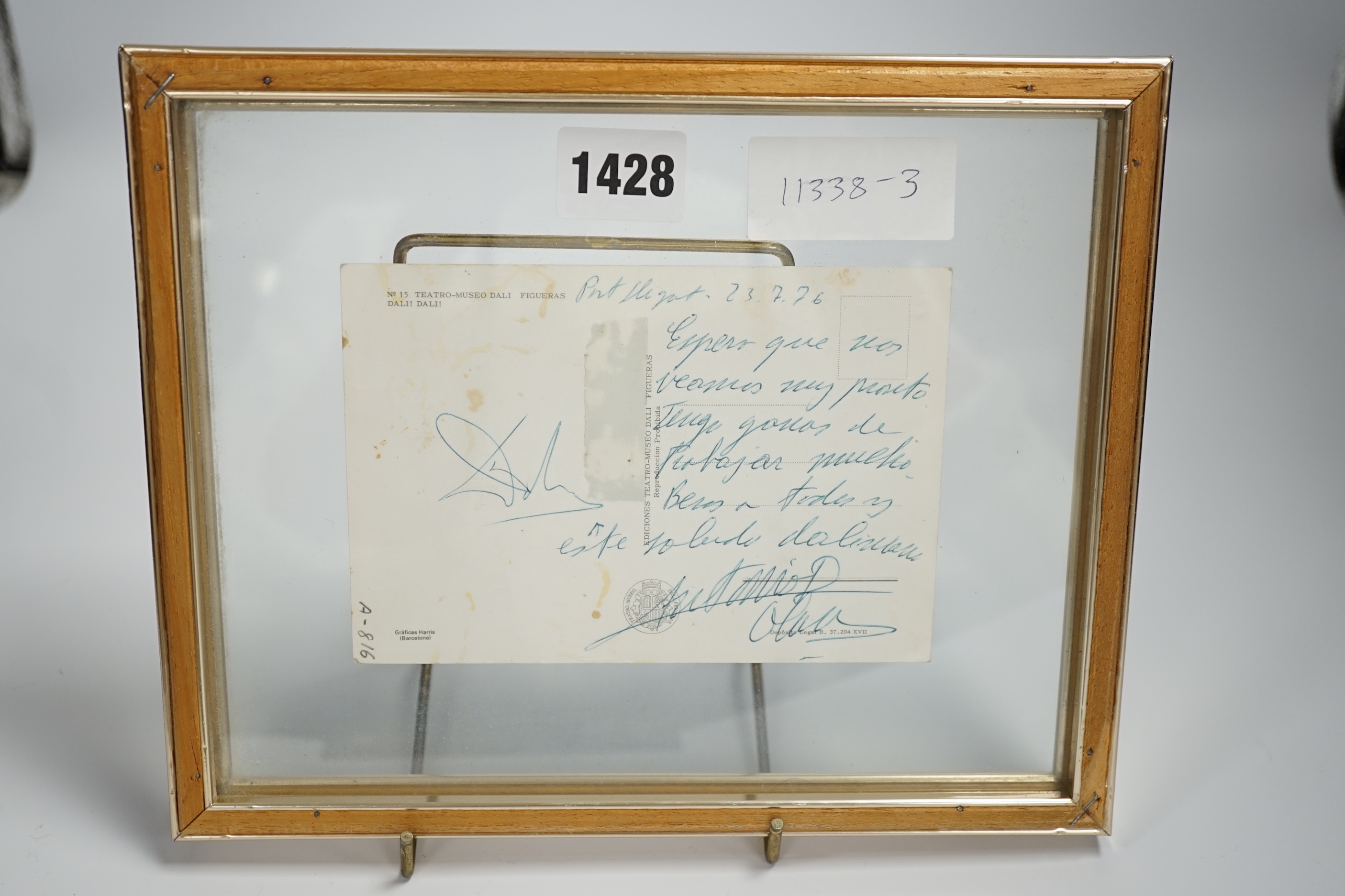 A framed Salvador Dali postcard signed with his autograph on reverse